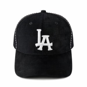 Black baseball cap with white LA embroidery and corduroy texture on white background.